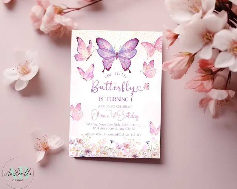 May include: A pink and purple butterfly birthday invitation with a floral design. The text reads "Our Little Butterfly is Turning 1. Join us to celebrate Olivia's 1st Birthday. Saturday, November 18th, 200 to 400 pm. 1234 Arawhere st, Any Cly, ST. Please RSVP to NameABC at 123 415 3456."
