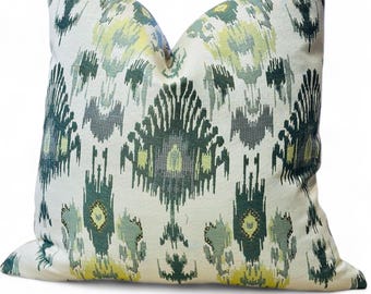 May include: A white throw pillow with a green and yellow ikat pattern.