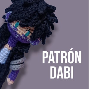 May include: Crocheted amigurumi doll of Dabi from the anime My Hero Academia. The doll is wearing a purple and black costume with a teal mask. The doll is lying on its side with its head tilted back. The text "PATRÓN DABI" is written in white letters on a purple background.