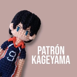 May include: Crocheted amigurumi figure of a boy with black hair, wearing a blue and orange volleyball uniform with the number 9 on the front. The text "PATRÓN KAGEYAMA" is in white letters on a light brown background.
