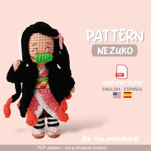 May include: A crocheted Nezuko doll with black hair, a pink kimono, and a green mouth guard. The doll is a PDF pattern, with text that reads "PATTERN NEZUKO" and "PDF PATTERN ENGLISH - ESPAÑOL".