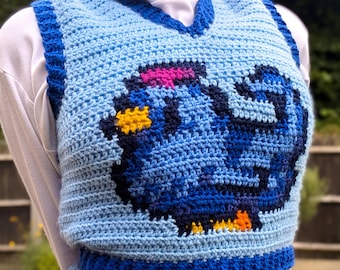 May include: A blue crocheted vest with a colorful pixelated bird design. The vest has a blue, yellow, pink, and white color scheme.