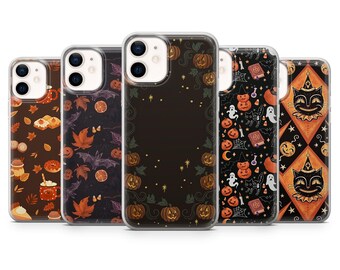 May include: Set of five clear phone cases with different Halloween-themed designs. The designs include pumpkins, bats, ghosts, and cats. The cases are all compatible with iPhone 13 Pro.