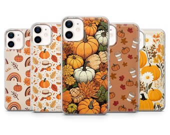 May include: A collection of phone cases with autumn-themed designs. The cases feature illustrations of pumpkins, leaves, and coffee cups in shades of orange, brown, and white. The cases are arranged in a row, showcasing the variety of designs.