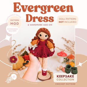 May include: A crochet doll wearing a dark red dress with puffy orange sleeves and a matching headband. The image includes text: Evergreen Dress & Wardrobe Add-on, Doll Pattern Not Included, Accessories Included, Keepsake Collection, Coty Loop.