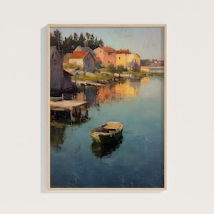 May include: A framed landscape painting depicts a serene waterscape with a small boat floating on the water. Buildings with red-tiled roofs line the shore, reflecting in the calm water. The artwork is in a wooden frame.