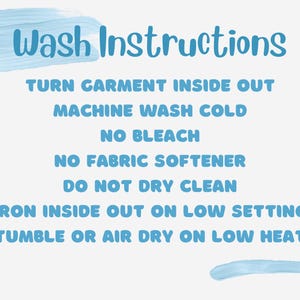 May include: Blue text on a white background with instructions for washing a garment. The instructions include turning the garment inside out, machine washing cold, no bleach, no fabric softener, do not dry clean, iron inside out on low setting, and tumble or air dry on low heat.