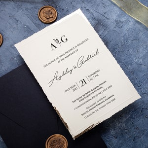 Custom black invitation with gold foil frame, minimalist design, wax seal, and deckled edges for a unique wedding touch