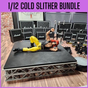 May include: A 1/12 Cold Slither Bundle featuring a wrestling action figure in yellow pants and a black vest, lying on a stage. The stage is surrounded by Marshall amplifiers and speakers. The text "1/12 COLD SLITHER BUNDLE" is at the top.