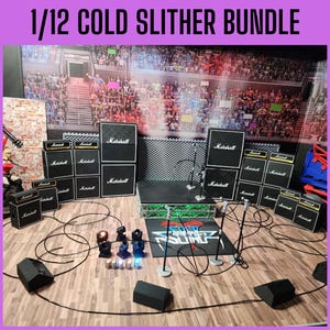 May include: A miniature stage setup with Marshall amplifiers, microphones, and lighting. The backdrop depicts a crowd in a stadium. The text "1/12 COLD SLITHER BUNDLE" is at the top. Cables and speakers are arranged on a wooden floor.