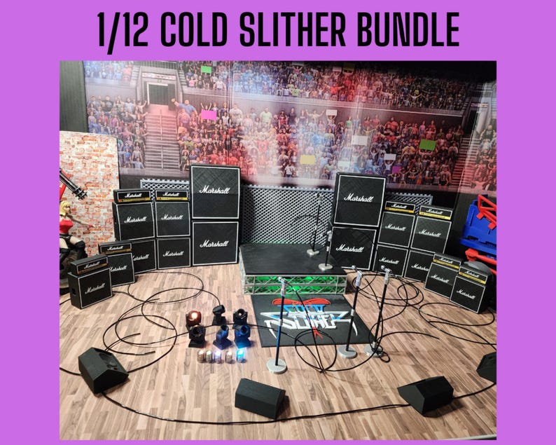 May include: A miniature stage setup with Marshall amplifiers, microphones, and lighting. The backdrop depicts a crowd in a stadium. The text "1/12 COLD SLITHER BUNDLE" is at the top. Cables and speakers are arranged on a wooden floor.
