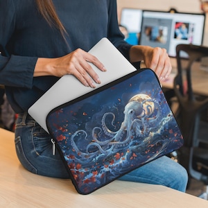 May include: A blue laptop sleeve with a white octopus illustration reaching for a glowing moon. The octopus is surrounded by swirling blue water and red and orange leaves.