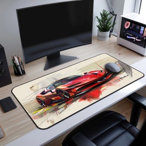 May include: A red sports car with black wheels and a white background. The car is on a desk mat with a computer mouse and a computer monitor in the background.