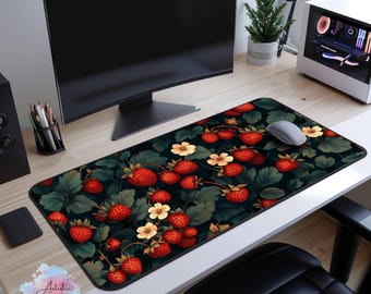 May include: A black and red mousepad with a pattern of strawberries and flowers. The mousepad is on a wooden desk with a computer monitor and a computer mouse.