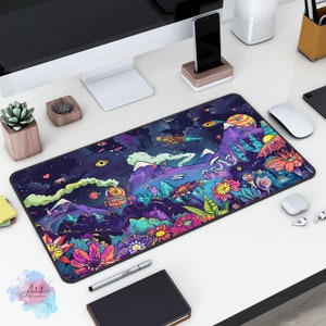 May include: A colourful, psychedelic-themed mouse mat with a galaxy background, mountains, flowers, and a robot. The mouse mat is on a white desk with a computer monitor, a phone, and other office supplies.