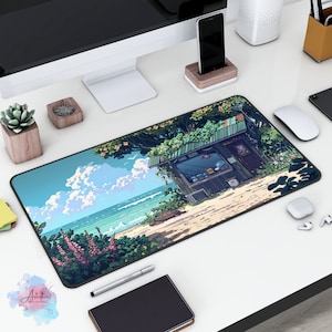 May include: A black and grey mouse mat featuring a colourful illustration of a beach scene. The scene includes a small wooden building with a green roof, palm trees, and a beach with blue water and white clouds. The mouse mat is on a white desk with a computer monitor, a mobile phone, and other office supplies.