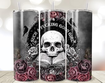May include: A stainless steel tumbler with a gothic design. The design features a skull, roses, and the text "SUCH A FUCKING GOOD GIRL". The tumbler has a straw and a black lid. The background is a dark, smoky gray.