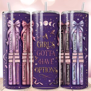 May include: A purple cylindrical tumbler with a straw, featuring a graphic of stacked books tied with ribbons and the text A GIRL'S GOTTA HAVE OPTIONS. The design includes moon phases, small dragons, and stars, with book titles like Celestial Gardens.