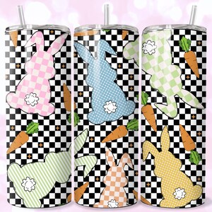 May include: Three stainless steel tumblers with a black and white checkered pattern. Each tumbler features a different colored bunny silhouette with a checkered pattern. The bunnies are pink, blue, and yellow. The tumblers also have a carrot design.