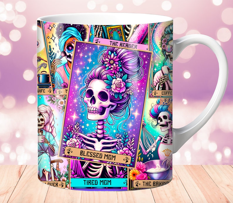 May include: White ceramic mug with a colorful design featuring a skeleton with flowers in its hair. The design includes multiple tarot card-like images with text such as "The Reader", "Blessed Mom", "Tired Mom", and "The Baking".