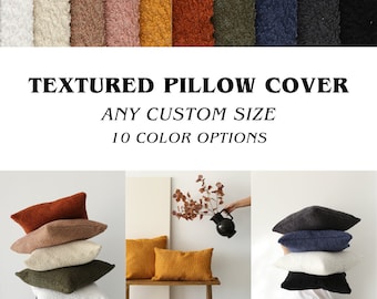 May include: A stack of textured pillow covers in various colors, including white, beige, brown, orange, yellow, green, blue, and black. The text "TEXTURED PILLOW COVER ANY CUSTOM SIZE 10 COLOR OPTIONS" is displayed above the pillows.