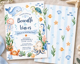 May include: A rectangular invitation card featuring watercolor sea creatures including a whale, turtle, jellyfish, seahorse, octopus, and crab. The text reads: Please join us Beneath the Waves, Ethan is turning One, Saturday November 9, 2:00 PM - 5:00 PM, 456 Seaside Cove, Ocean View, CA 90210, RSVP to Olivia 555-234-6789.