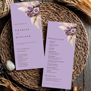 May include: Two lilac wedding programs with floral decorations. The programs display the names "Charles and Jennifer" and the ceremony schedule. The programs are adorned with dried flowers and roses.