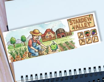 May include: A watercolor bookmark featuring a farmer in overalls tending a garden with a house and barn in the background. The bookmark has the text "Stardew Valley" and icons of tools and crops.