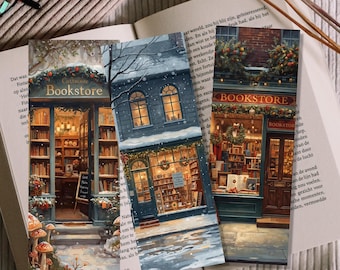 May include: Three decorative bookmarks featuring winter scenes of cozy bookstores. Each bookmark showcases a different bookstore facade, with snow-covered roofs, warm interior lights, and the word "Bookstore" displayed prominently.
