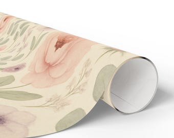 May include: Rolled wrapping paper featuring a watercolor floral design. The pattern includes large pink and purple flowers, green leaves, and delicate white accents on a cream background. The paper is rolled up, showing the inside of the roll.