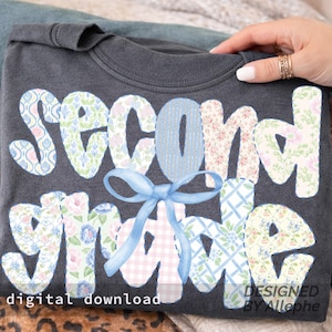 May include: Dark gray t-shirt with the words "SECOND GRADE" in a patchwork design. The letters are decorated with floral and patterned fabrics, and a blue bow is centered below the word "SECOND". The words "digital download" and "DESIGNED BY Allephe" are also visible.