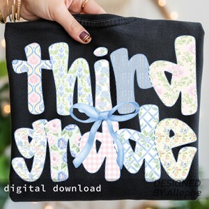 May include: Black t-shirt with the words "third grade" in a floral and patterned design. A light blue bow is centered between the words. The words "digital download" are at the bottom left.