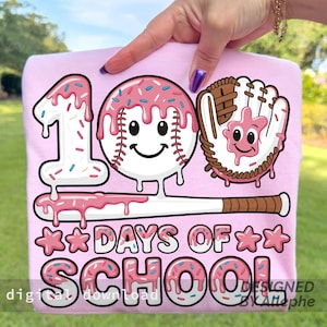 May include: A pink t-shirt with a playful design for the 100th day of school. The graphic includes a baseball, baseball glove, and the number 1, all decorated with pink icing and sprinkles. The words "DAYS OF SCHOOL" are also included.