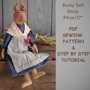 May include: A PDF sewing pattern and step-by-step tutorial for making a 17-inch bunny doll named Emily. The doll is wearing a blue dress with a white and blue striped apron and a red headband.