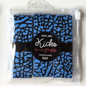 May include: Three rolls of blue and black elephant print grip tape packaged in a clear plastic bag. A circular black label on the front features the text @KICKS_GRIPS, Kicks grips, SNEAKERHEAD APPROVED, and TACKY in white and red lettering.