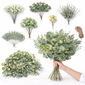 May include: Assortment of artificial greenery, including eucalyptus and small white flowers. Bundles of various sizes are displayed, some tied with twine. A large bouquet is held by a person, showcasing the variety of foliage.