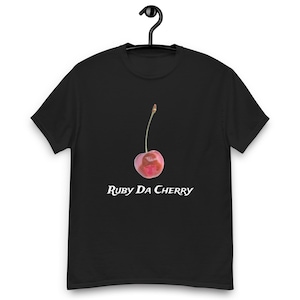 May include: Black t-shirt featuring a white cherry graphic and the text "Ruby Da Cherry" printed on the front.
