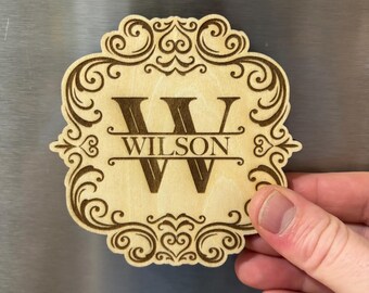 May include: A wooden magnet with a decorative frame and the initial "W" and the name "WILSON" engraved in the center.