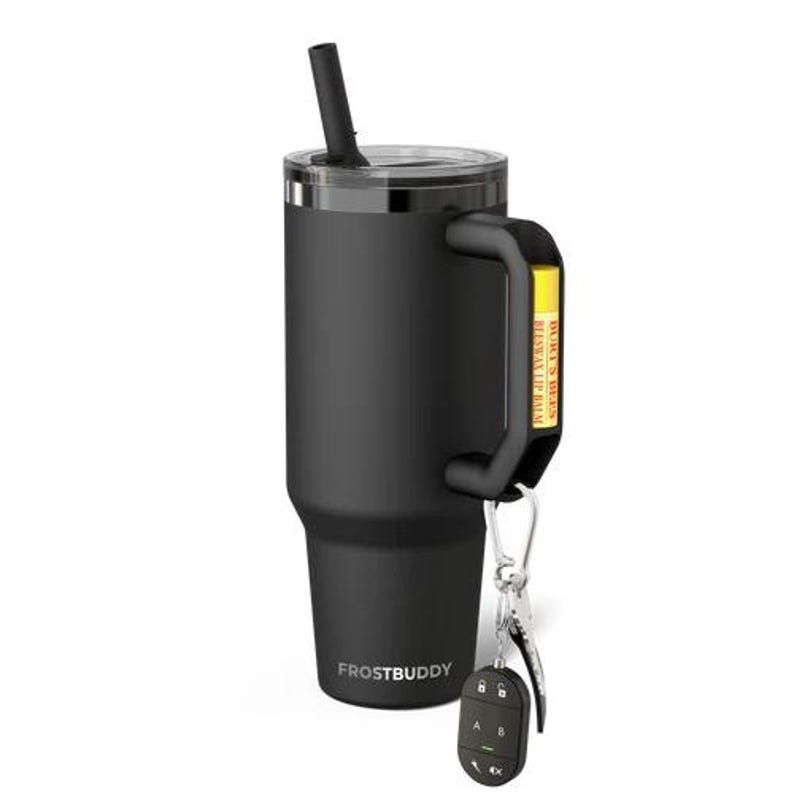 May include: Black insulated tumbler with a handle, a lid, and a reusable straw. The tumbler has the word "FROSTBUDDY" printed on the side. A key chain with keys and a remote is attached to the handle. A yellow tag with text is attached to the handle.