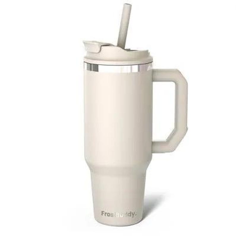 May include: A cream-colored insulated tumbler with a handle and a straw. The tumbler has a lid with a sliding closure and a silver band around the top. The brand name "Frostbuddy" is printed on the bottom.