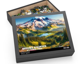 May include: A 500-piece jigsaw puzzle featuring a scenic view of Mount Rainier National Park. The puzzle box shows a colorful illustration of a snow-capped mountain with a lake in the foreground. The box also includes the text "Mount Rainier National Park" and "16x20 Puzzle 500 pcs Ages 9+".