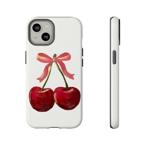 May include: White iPhone case with a painting of two red cherries with a pink bow on the stems.