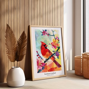 May include: A framed print of a colorful geometric illustration of a Northern Cardinal perched on a branch with pink and yellow flowers. The text "Northern Cardinal" and "CARDINALIS CARDINALIS" is printed below the image.
