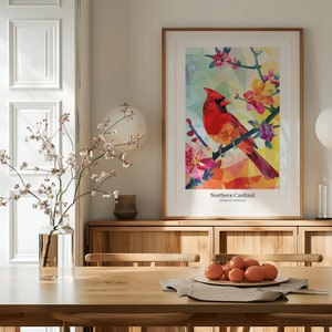 May include: A framed print of a geometric illustration of a Northern Cardinal perched on a branch with pink blossoms. The print is titled "Northern Cardinal" with the scientific name "Cardinalis cardinalis" below.