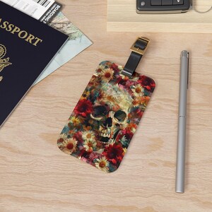 May include: A luggage tag with a colorful floral pattern and a skull in the center. The skull is white with black details and is surrounded by red, pink, yellow, and blue flowers.