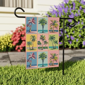 May include: A colorful garden flag with a repeating pattern of palm trees in different colors and shades. The flag is divided into nine squares, each featuring a palm tree with a blue ocean and sandy beach background.