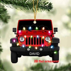 May include: A red Jeep ornament with a string of colorful lights draped across the front. The word "DAVID" is displayed on the license plate. The text "2D flat ornament" is at the bottom.