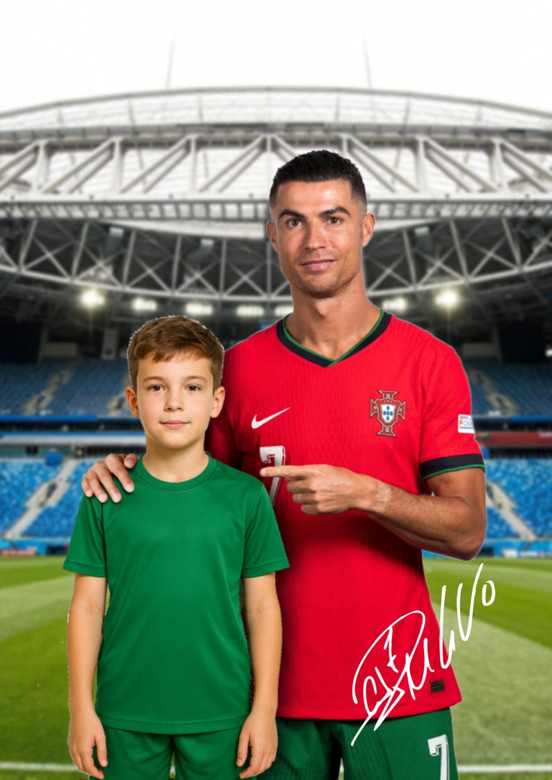 May include: A man wearing a red soccer jersey with the Portuguese flag on the chest, is standing with his arm around a young boy wearing a green soccer jersey. The man is pointing to the number 7 on his jersey. The man's signature is visible on the jersey. The background is a blurry image of a soccer stadium.