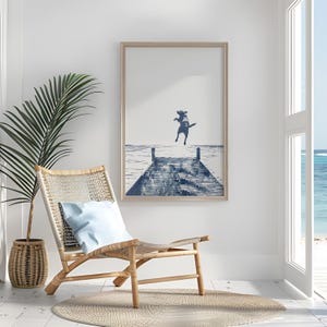 a room with a chair and a picture hanging on the wall
