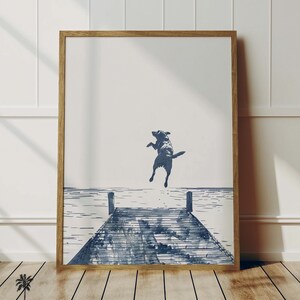 a picture of a dog jumping into the water